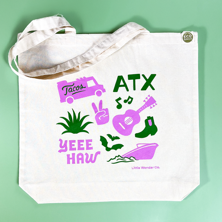 This Austin tote bag has hand-drawn icons that represent Austin, like a taco truck, boot, guitar, bats, a boat, and cactus. It's perfect for gifting and souvenirs.