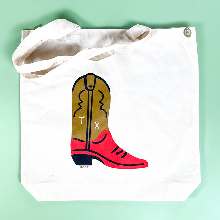 A white cotton tote bag with a hand-drawn cowboy boot printed on it. It makes a great gift or Texas souvenir!