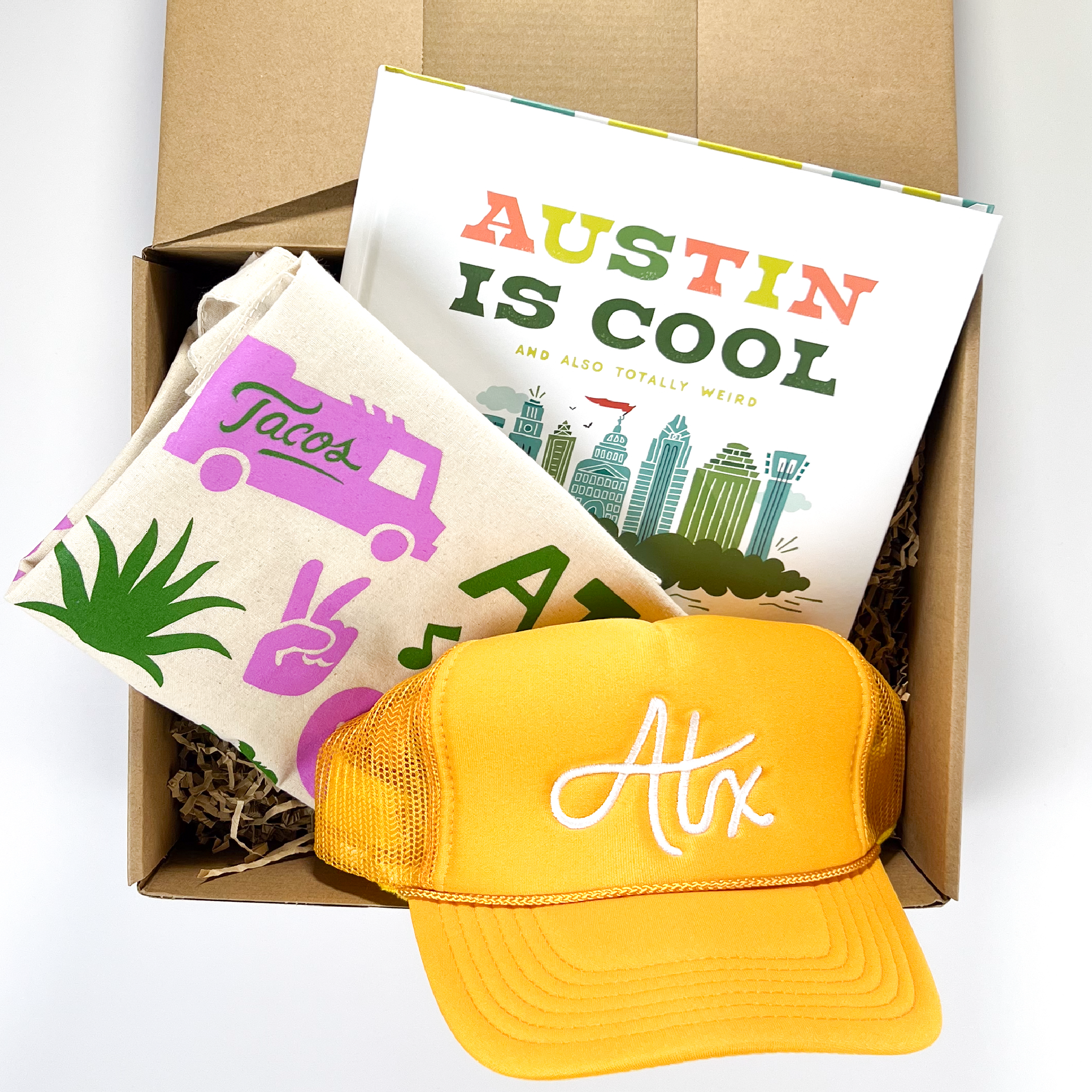 An Austin gift box that includes an Austin book, Austin tote bag, and an ATX Austin cap.