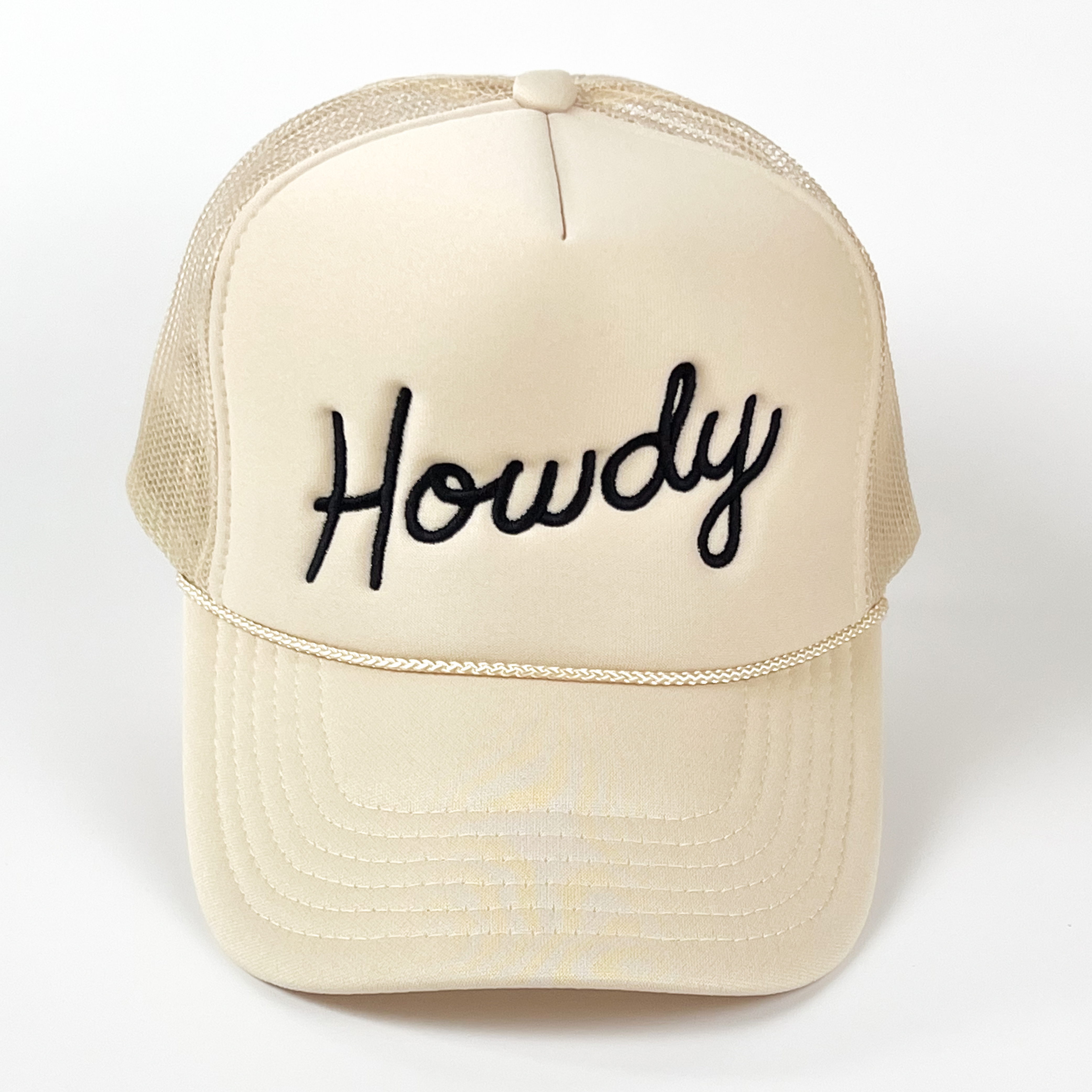 An off-white trucker cap with 'Howdy' embroidered in a black colored thread.