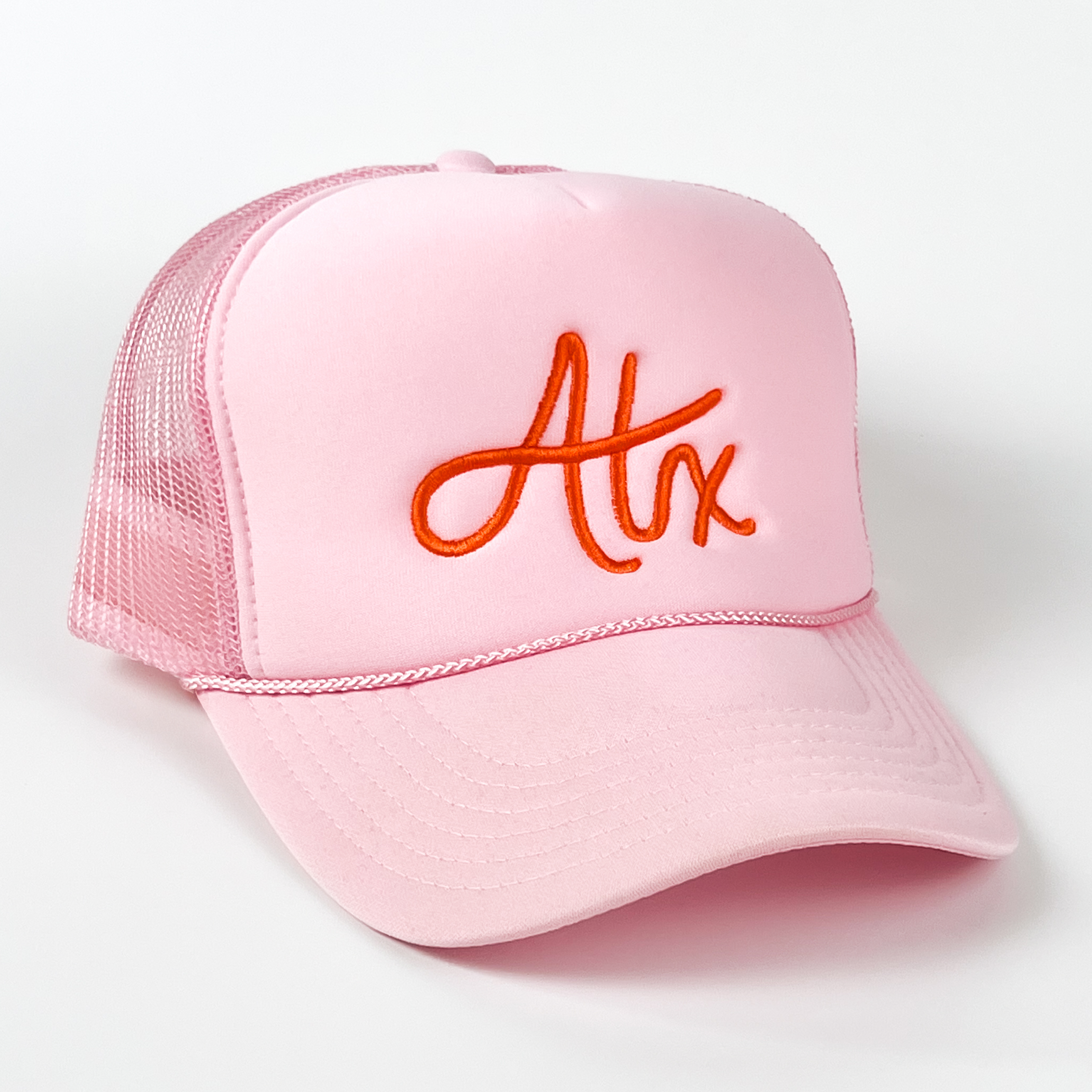 This Austin cap is boldly fun, with orange embroidery on a light pink cap. It has hand-drawn lettering and is quickly becoming one of our bestsellers!